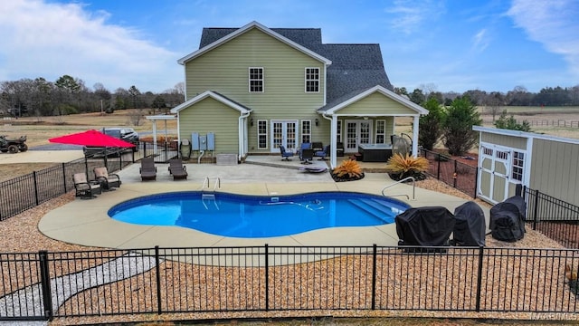 view of swimming pool with french doors and a patio