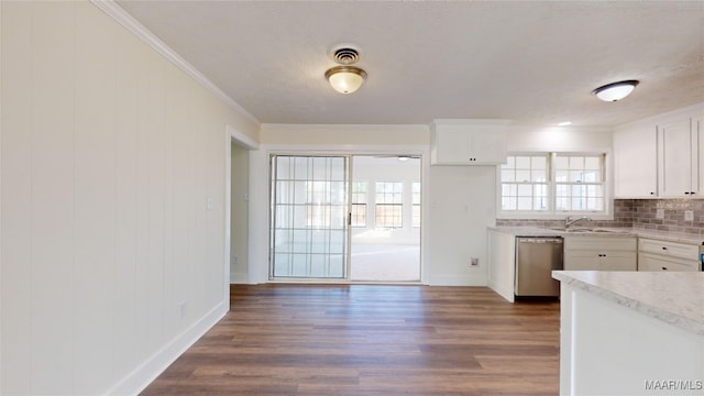 kitchen with sink, white cabinets, stainless steel dishwasher, crown molding, and dark wood-type flooring