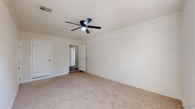 unfurnished bedroom featuring light carpet, crown molding, and ceiling fan