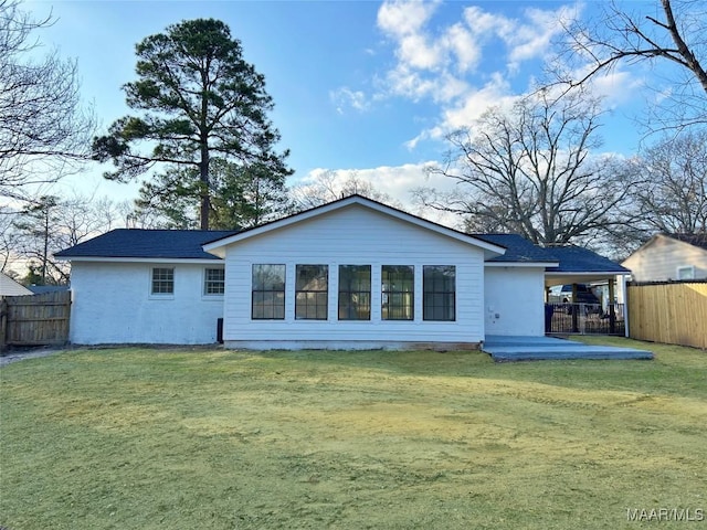 rear view of property featuring a yard