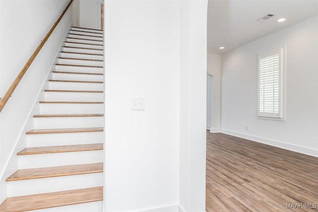 stairway with wood-type flooring