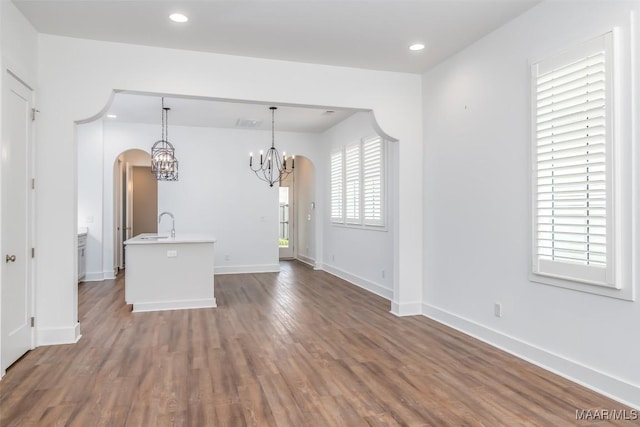 interior space with an inviting chandelier and dark hardwood / wood-style flooring