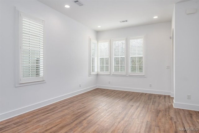 spare room with hardwood / wood-style flooring