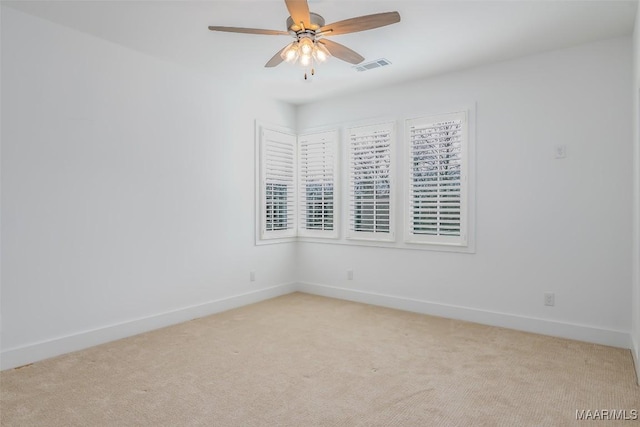 unfurnished room featuring light carpet and ceiling fan