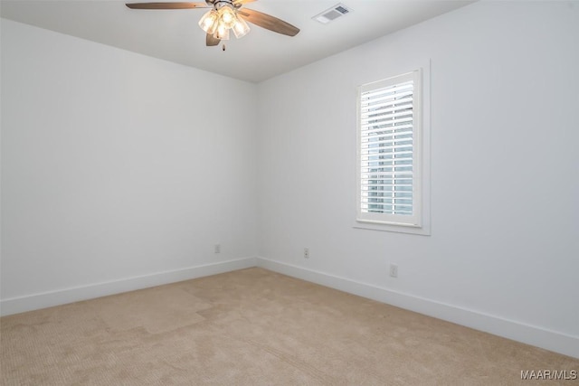 spare room featuring light carpet and ceiling fan