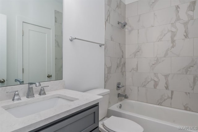 full bathroom with vanity, toilet, and tiled shower / bath combo