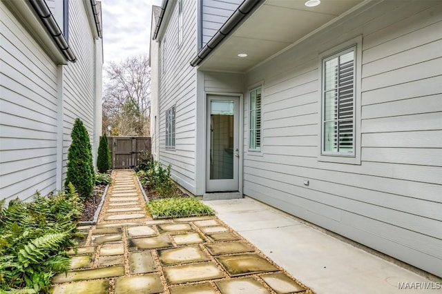 view of exterior entry with a patio