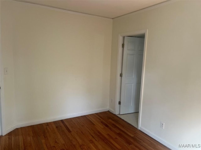 empty room with baseboards and wood finished floors