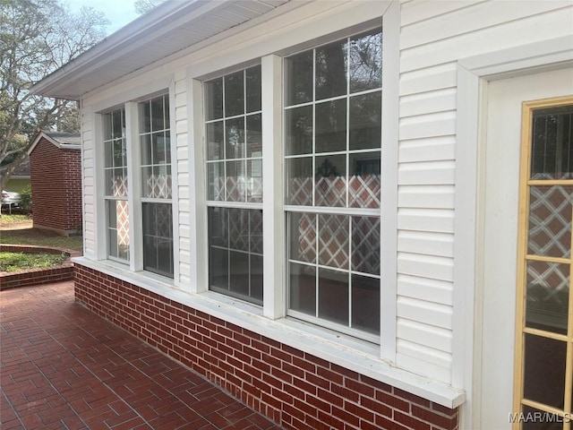 view of side of property featuring brick siding