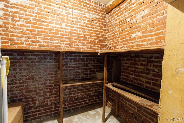 wine cellar featuring brick wall