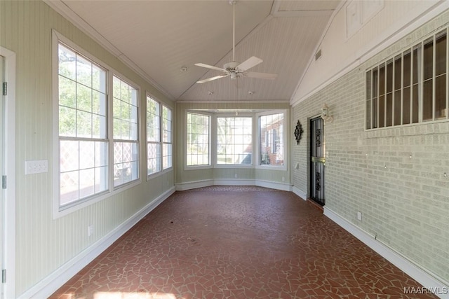 unfurnished sunroom featuring vaulted ceiling, a ceiling fan, and a healthy amount of sunlight