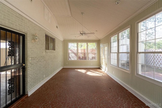 unfurnished sunroom with a ceiling fan and lofted ceiling