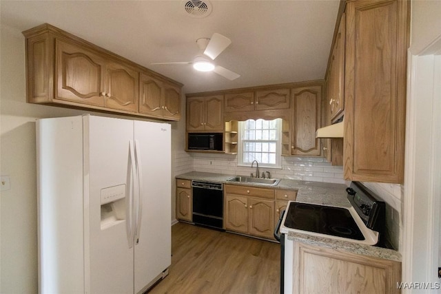 kitchen with white refrigerator with ice dispenser, a sink, range with electric cooktop, dishwasher, and under cabinet range hood