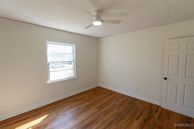 unfurnished room featuring ceiling fan, a textured ceiling, baseboards, and wood finished floors