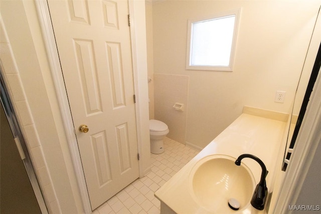 bathroom featuring toilet, tile patterned floors, and vanity