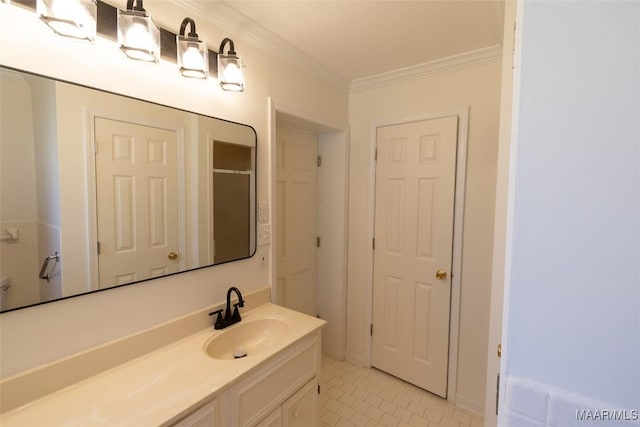 bathroom with ornamental molding, a shower with shower door, and vanity