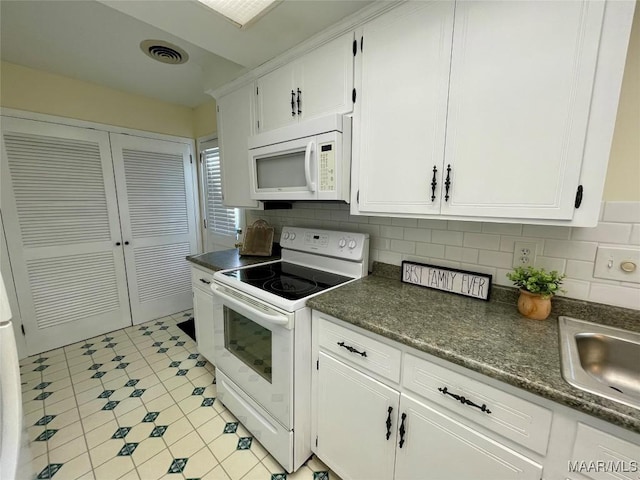 kitchen featuring white cabinetry, sink, white appliances, and decorative backsplash