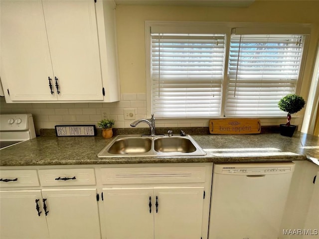 kitchen featuring white cabinetry, sink, backsplash, and white appliances