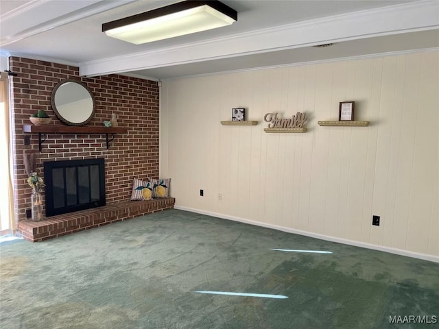 unfurnished living room with a brick fireplace, dark carpet, ornamental molding, and beamed ceiling