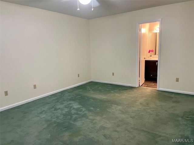 unfurnished bedroom with connected bathroom and carpet floors