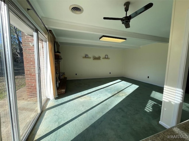 empty room featuring beamed ceiling and dark colored carpet