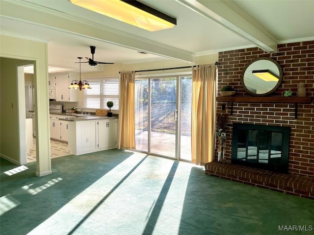 unfurnished living room featuring sink, crown molding, carpet floors, a fireplace, and beamed ceiling