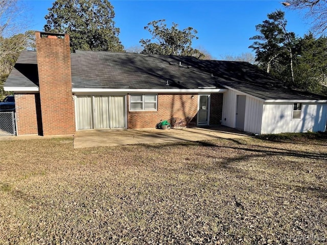 rear view of property with a yard and a patio area