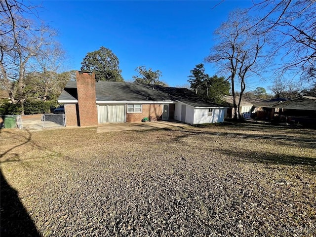 rear view of property featuring a lawn and a patio area