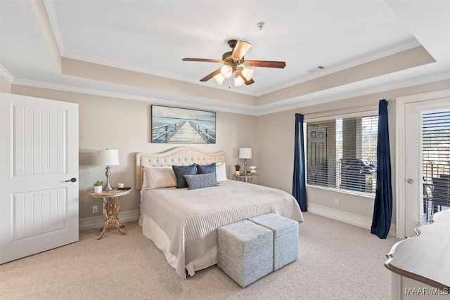 bedroom featuring crown molding, light colored carpet, and a tray ceiling