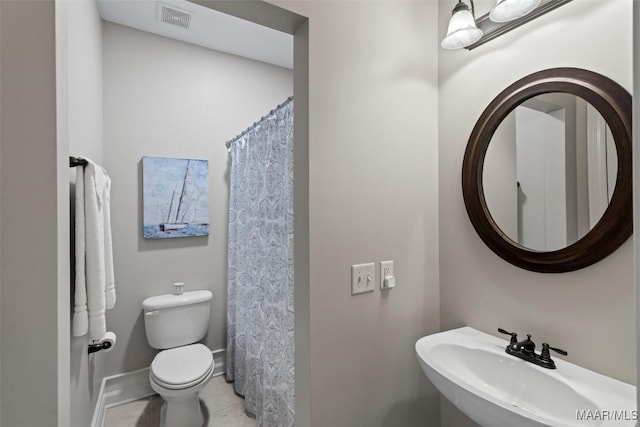 bathroom featuring tile patterned flooring, sink, and toilet