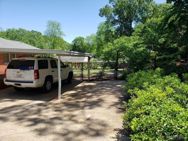 view of parking / parking lot featuring a carport