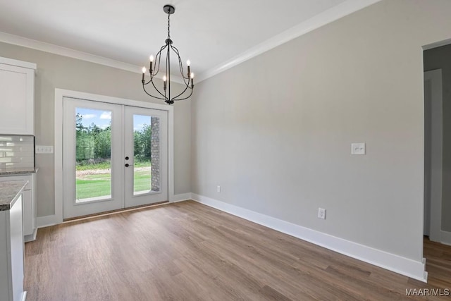 116 Madix Dr, Eclectic, AL 36024 - unfurnished dining area featuring french doors, a chandelier, wood finished floors, and crown molding
