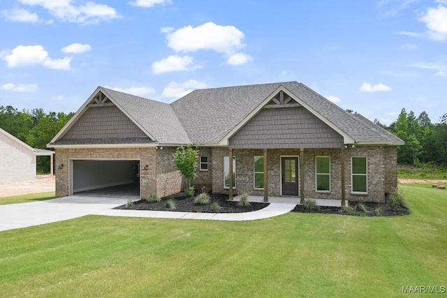 116 Madix Dr, Eclectic, AL 36024 - craftsman inspired home featuring an attached garage, a front lawn, driveway, brick siding, and a porch