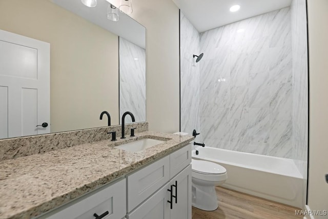 116 Madix Dr, Eclectic, AL 36024 - full bath with vanity, wood finished floors, and washtub / shower combination