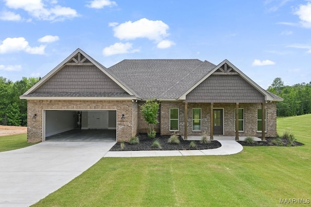 116 Madix Dr, Eclectic, AL 36024 - craftsman-style home featuring a garage, driveway, a front yard, and brick siding