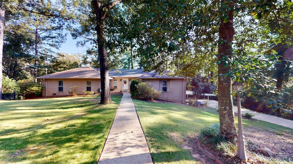 ranch-style home with a front lawn