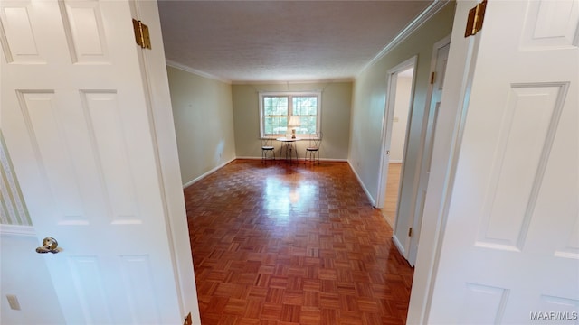 spare room with crown molding, dark parquet floors, and a textured ceiling