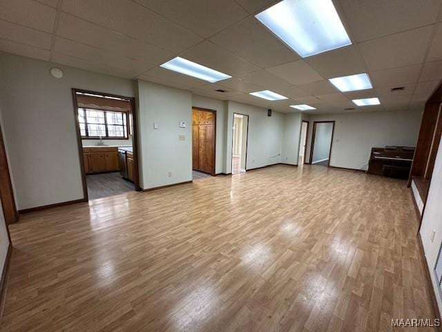 unfurnished room featuring light hardwood / wood-style flooring and a drop ceiling