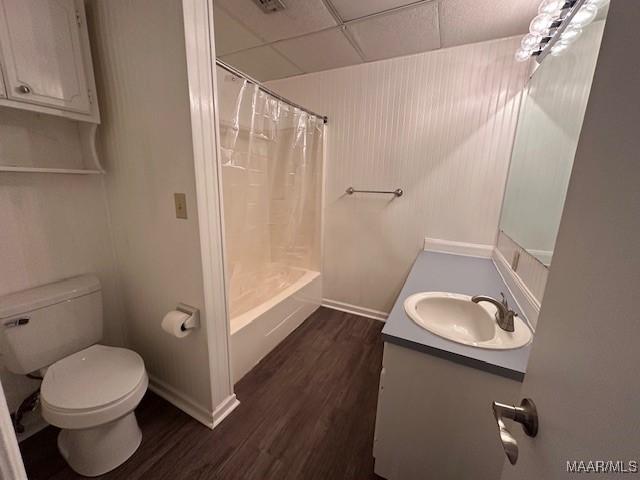 full bathroom featuring a paneled ceiling, vanity, toilet, and wood-type flooring