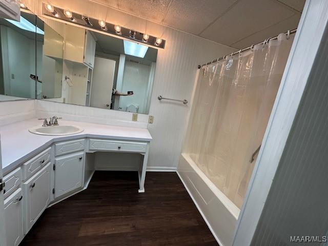 bathroom featuring hardwood / wood-style flooring, vanity, and shower / bath combo