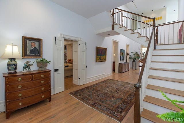 entrance foyer featuring a high ceiling and light hardwood / wood-style floors