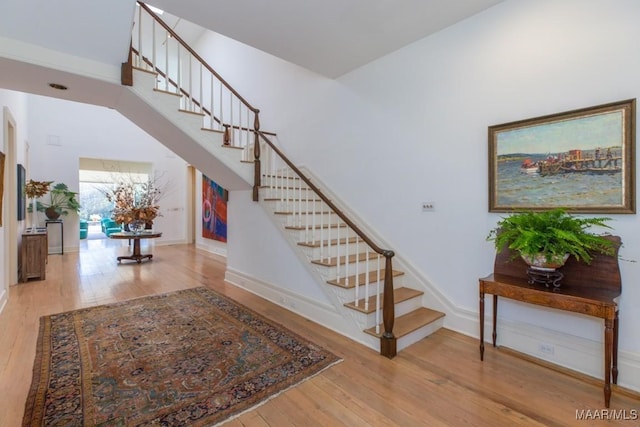 staircase featuring wood-type flooring