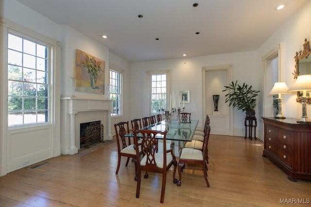 dining space featuring a wealth of natural light and light hardwood / wood-style flooring