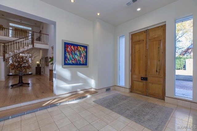 tiled foyer featuring a wealth of natural light