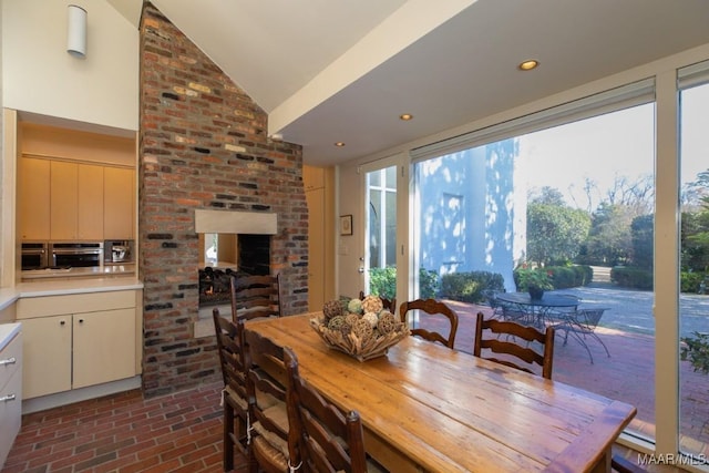 dining space featuring vaulted ceiling