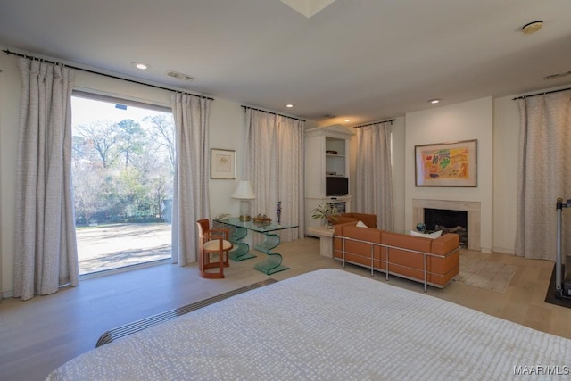 bedroom featuring access to exterior and light hardwood / wood-style floors