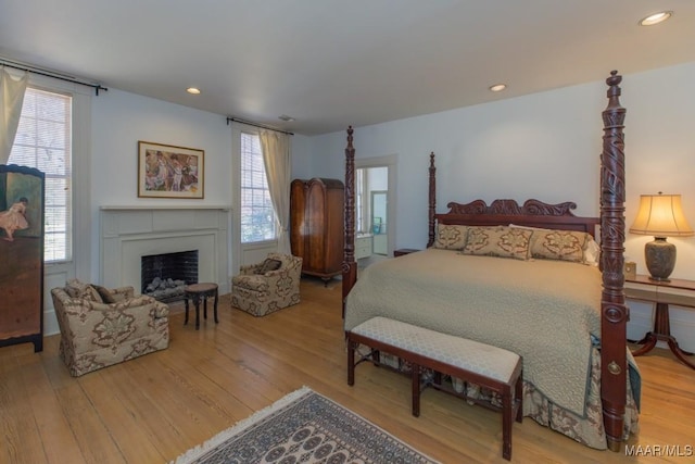 bedroom featuring multiple windows and hardwood / wood-style floors