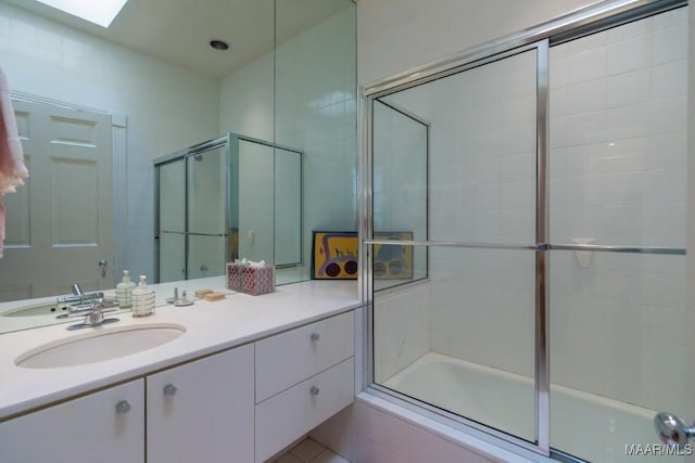 bathroom featuring enclosed tub / shower combo and vanity