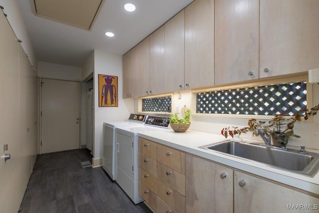 laundry room with cabinets, washing machine and clothes dryer, dark wood-type flooring, and sink