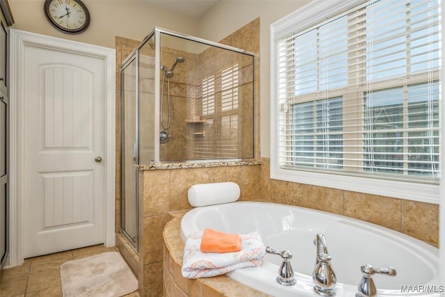 bathroom with tile patterned floors, shower with separate bathtub, and a wealth of natural light